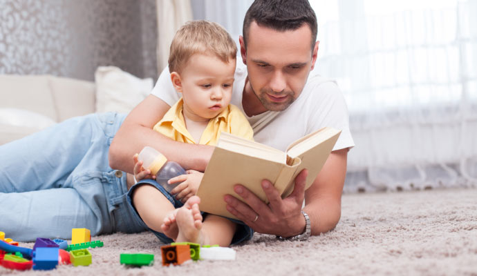 Person relaxing with a child on clean carpet