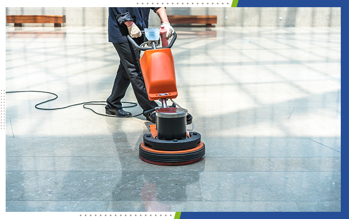 professional worker cleaning floor with cleaning equipment