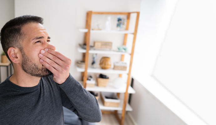 A person in a room with unpleasant odor